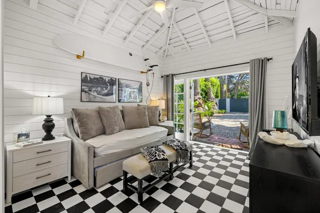 a living room with furniture and large windows
