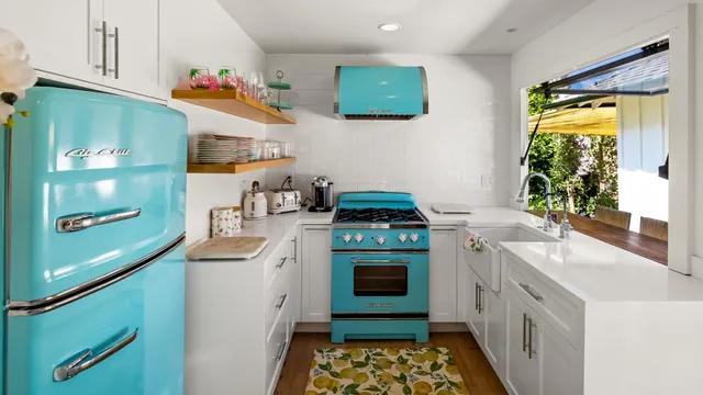 a kitchen with stainless steel appliances a stove a sink and a refrigerator