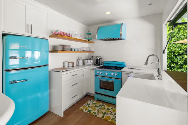 a kitchen with a sink cabinets and appliances