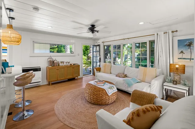 a living room with furniture gym equipment and a large window