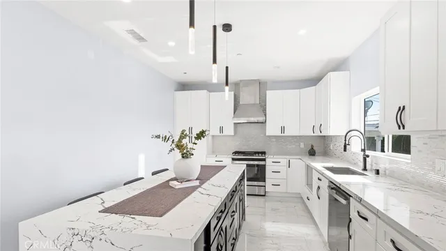 a kitchen with a sink refrigerator and cabinets