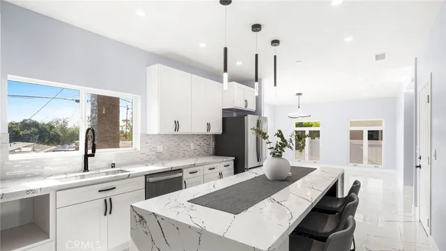 a kitchen with a sink stove and refrigerator