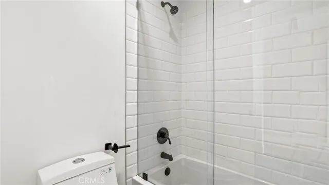 a bathroom with a sink a toilet a shower and a mirror