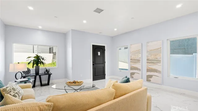 a living room with furniture and a potted plant