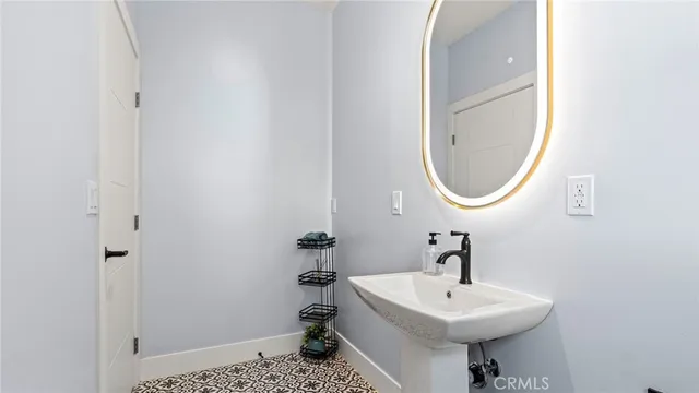 a bathroom with a sink a mirror and a toilet