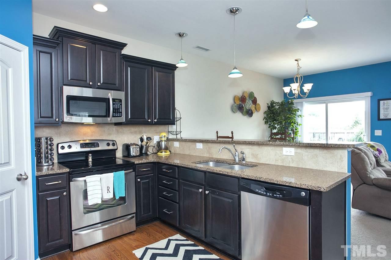 645 Smith Ridge Way Fuquay-Varina, NC 27526 - Photo 4 of 25 Wow Factor - The rich chocolatey colored cabinetry is just stunning!