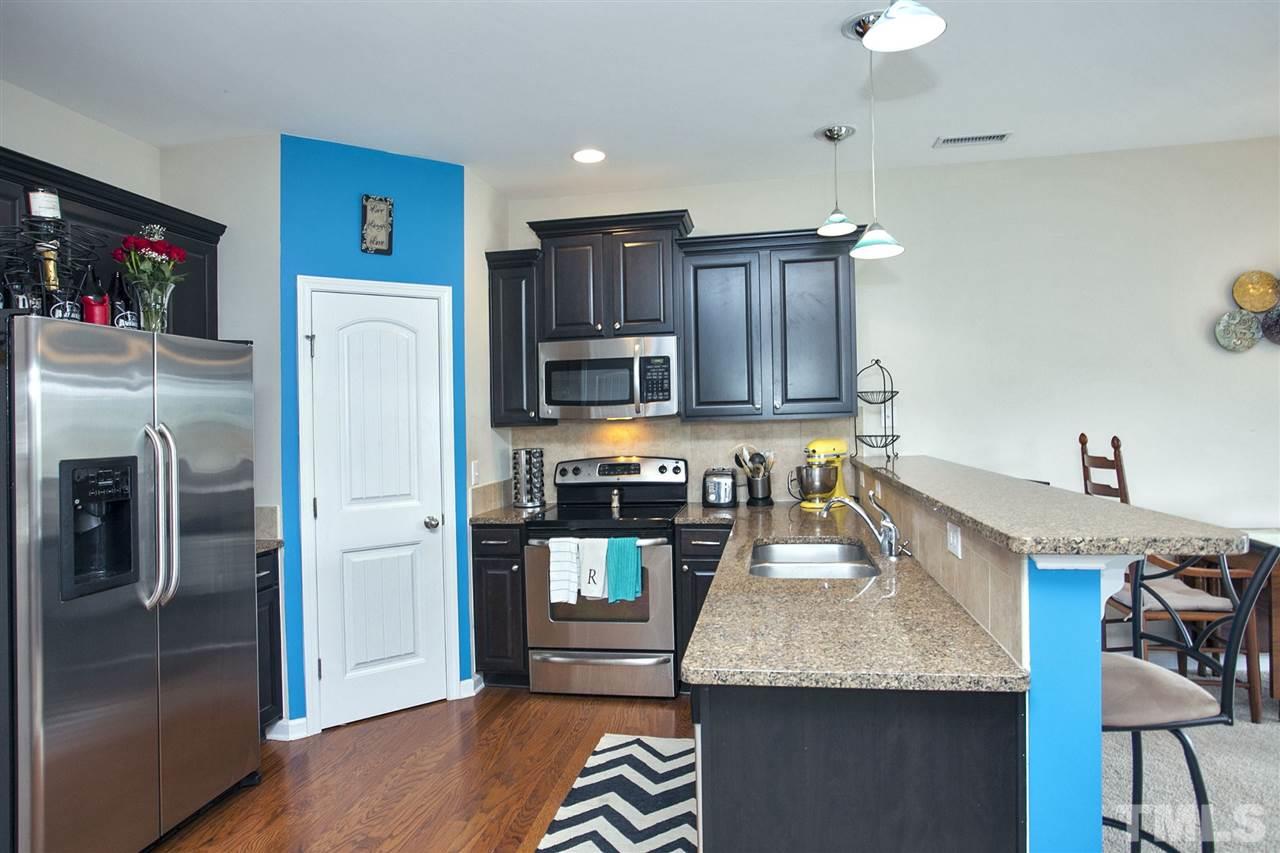 645 Smith Ridge Way Fuquay-Varina, NC 27526 - Photo 5 of 25 Elegant granite counter tops ... stainless appliances and a walk in pantry ... on my!