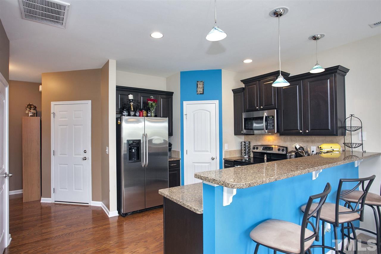 645 Smith Ridge Way Fuquay-Varina, NC 27526 - Photo 6 of 25 Great blue accented lighting fixtures highlight the eat in counter area ...