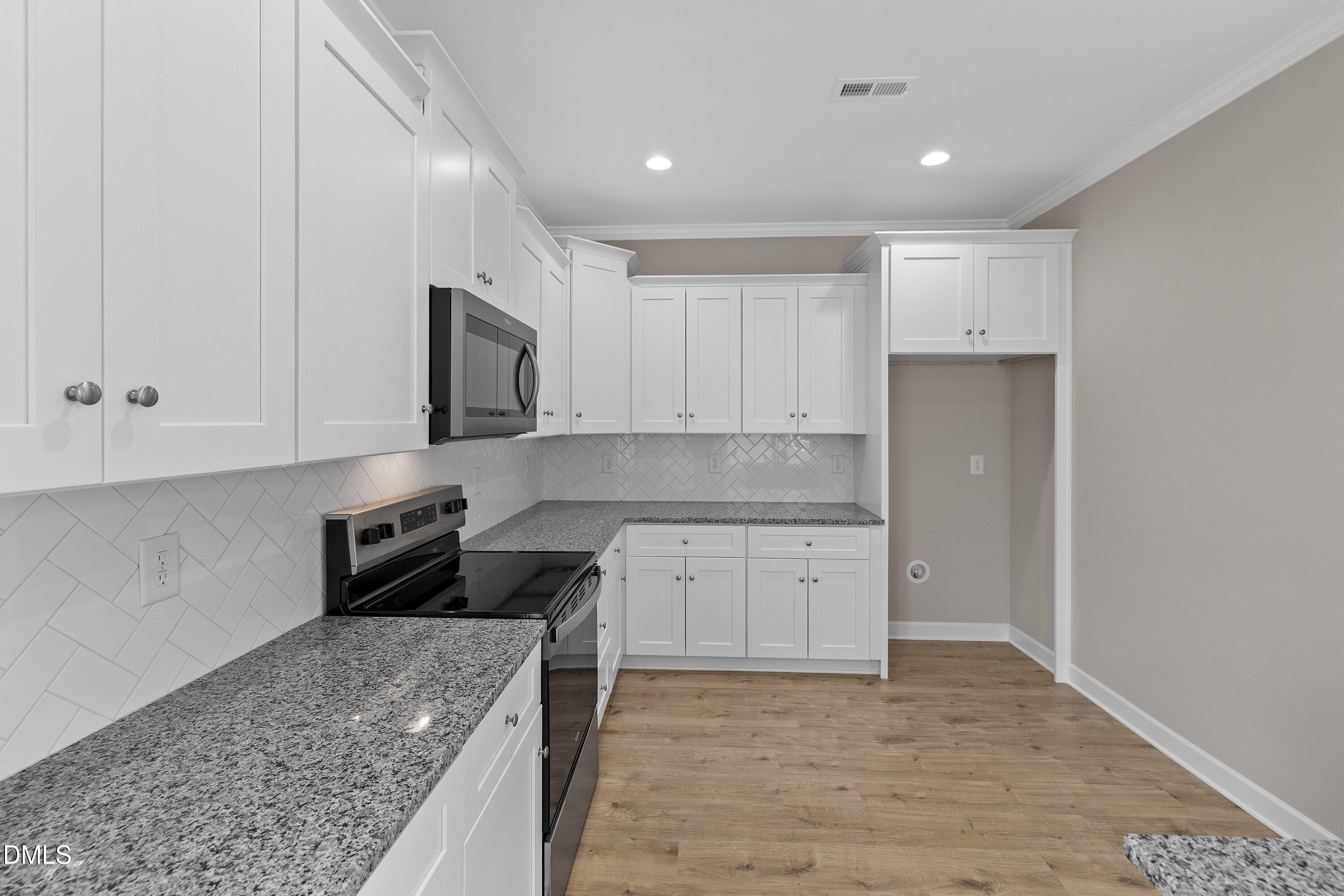 926 Micro Road West Selma, NC 27576 - Photo 22 of 41 a kitchen with granite countertop a stove and a sink
