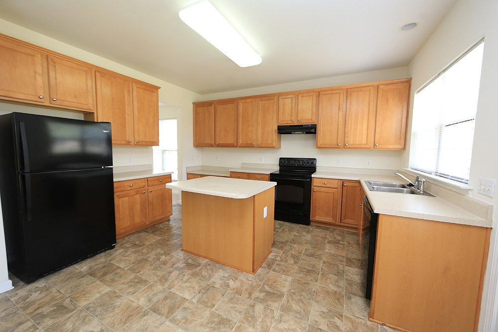 Spacious kitchen with island, stained cabinets, etc. Kitchen