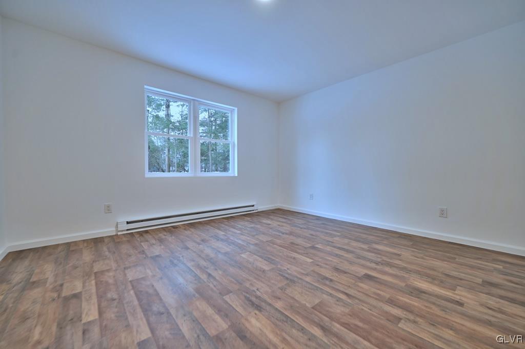 139 Winter Hill Road Effort, PA 18330 - Photo 17 of 50 a view of an empty room with wooden floor and a window