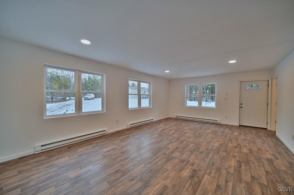 139 Winter Hill Road Effort, PA 18330 - Photo 8 of 50 an empty room with wooden floor and windows
