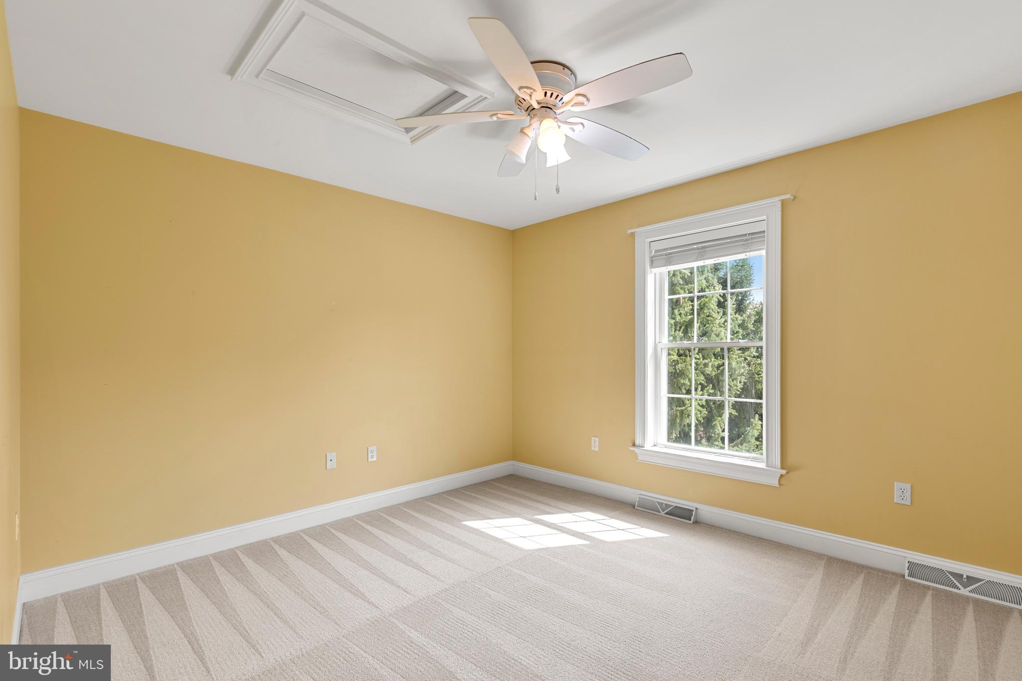 2717 Kreider Road Lititz, PA 17543 - Photo 23 of 33 an empty room with a chandelier fan and windows