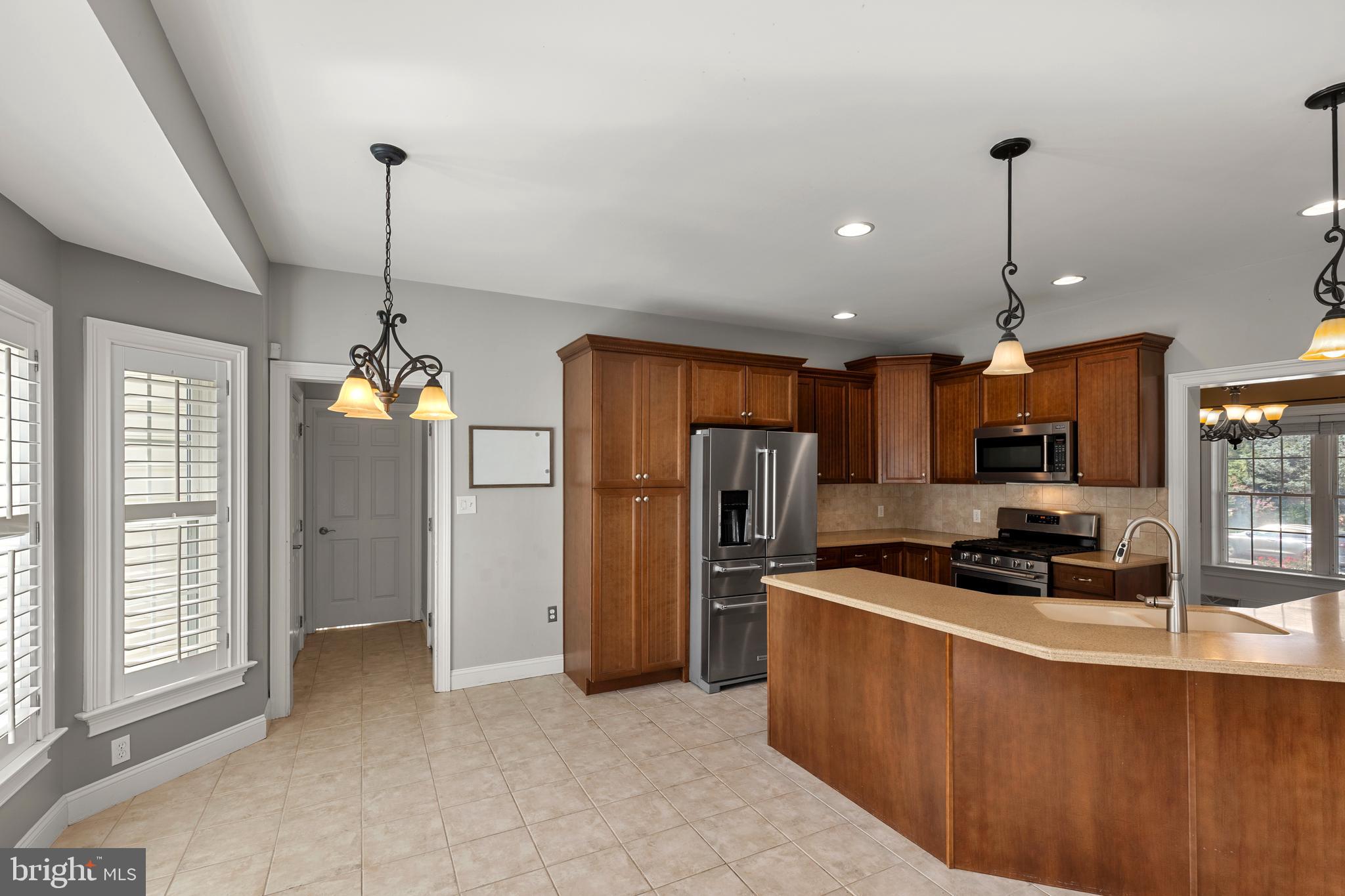 2717 Kreider Road Lititz, PA 17543 - Photo 9 of 33 a kitchen with stainless steel appliances granite countertop a refrigerator a sink a stove a microwave and island