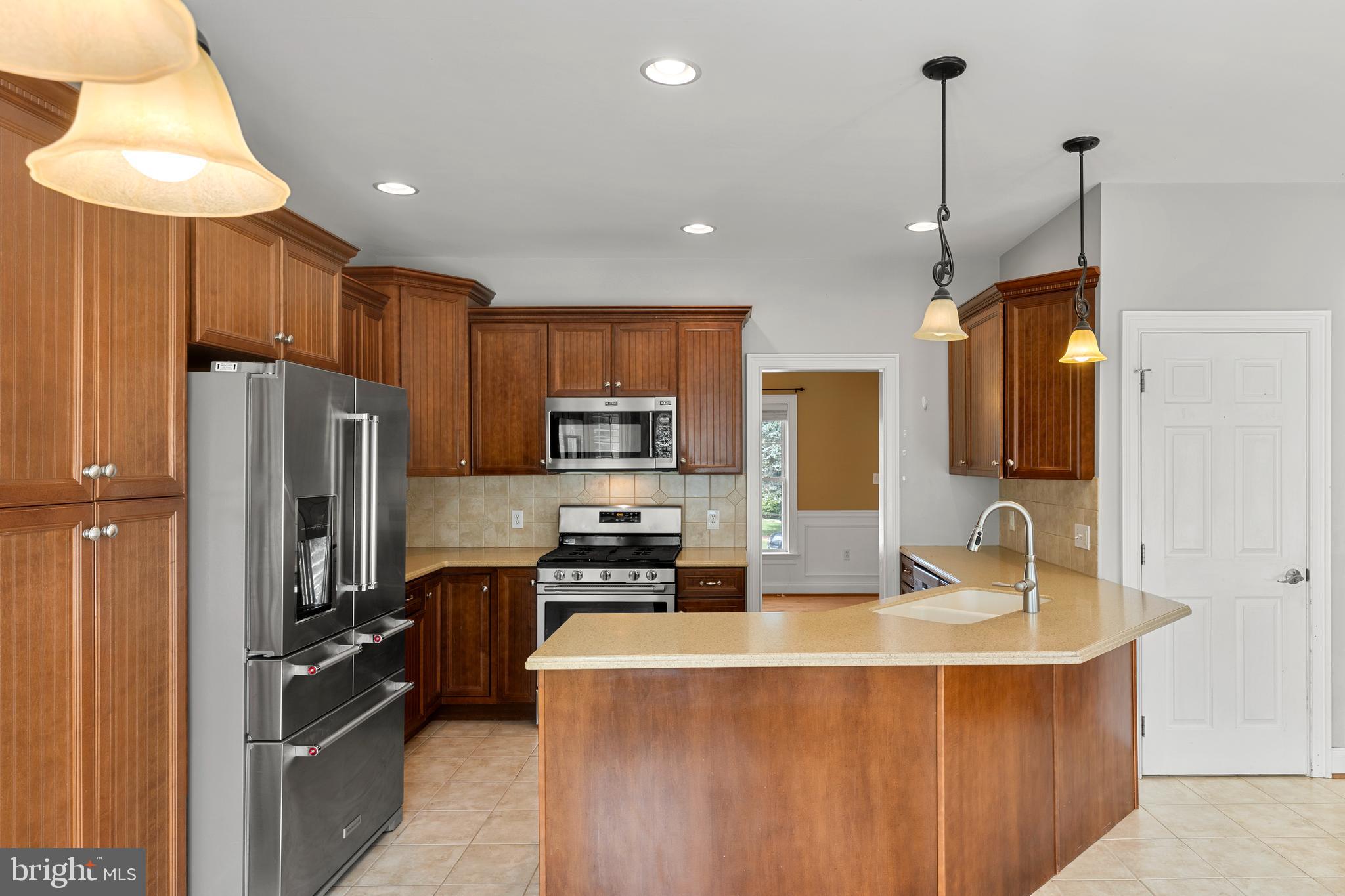 2717 Kreider Road Lititz, PA 17543 - Photo 10 of 33 a kitchen with kitchen island granite countertop a sink counter space cabinets and stainless steel appliances