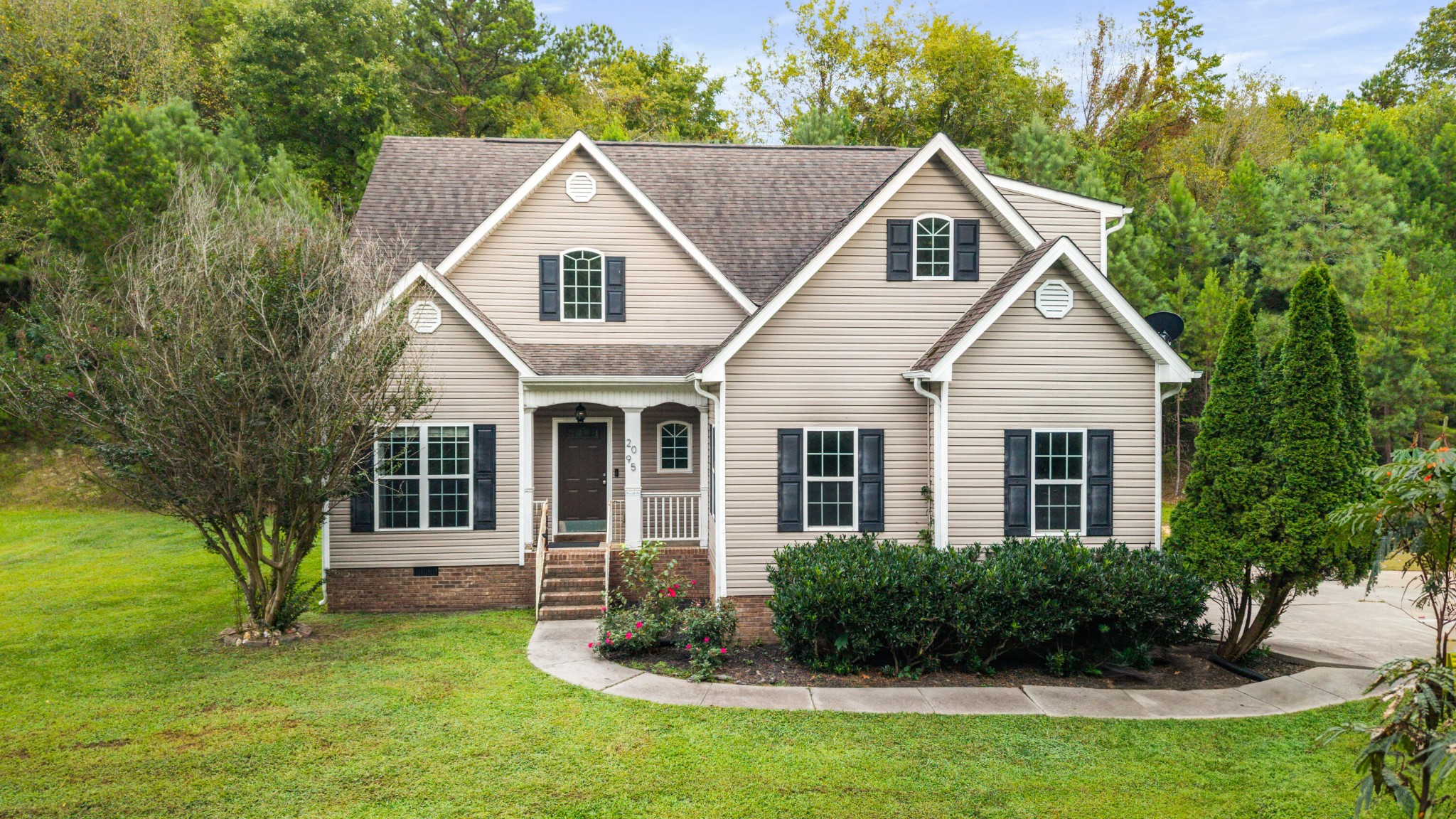 a front view of a house with a yard