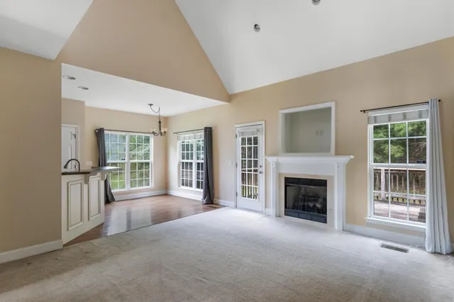 a view of a livingroom with an empty space and a fireplace
