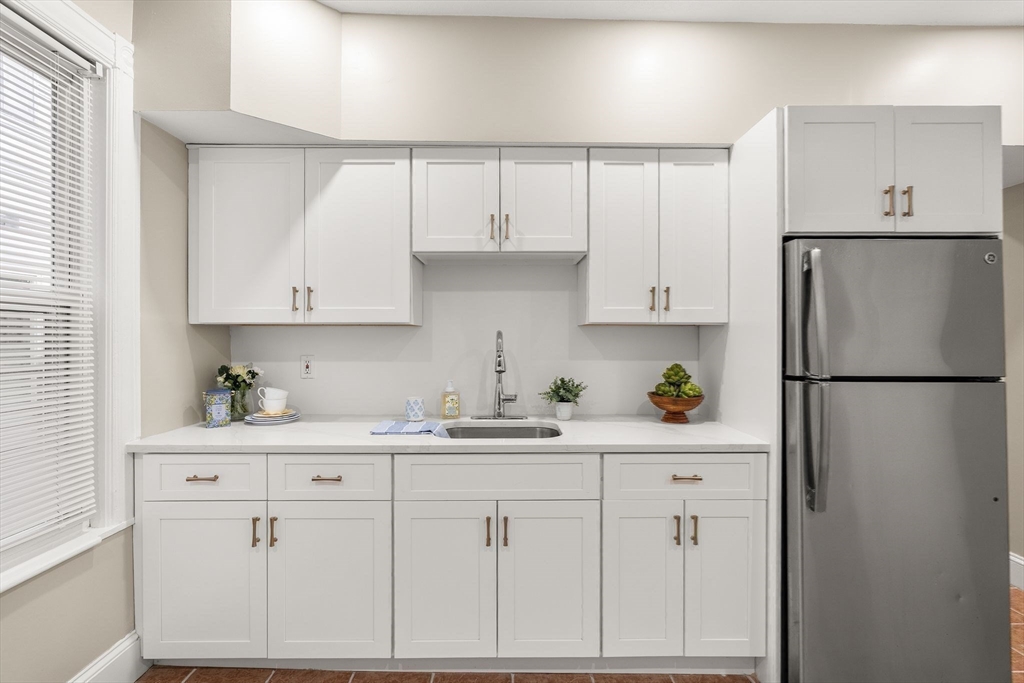 3 Spring Garden Street, Unit 1 Boston, MA 02125 - Photo 6 of 23 a kitchen with cabinets appliances a sink and a window