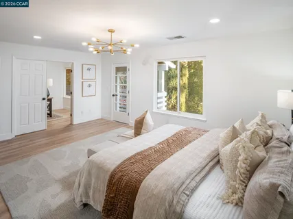 a bathroom with a tub a mirror and shower