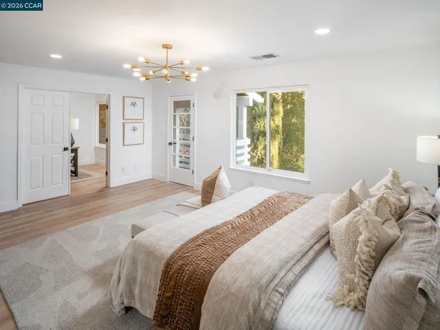 a bathroom with a tub a mirror and shower
