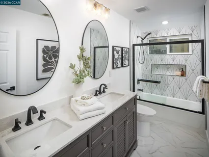 a backyard with table and chairs plants and wooden fence