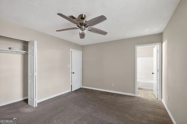 a view of a big room with a chandelier fan