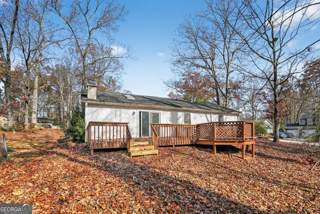 a view of a house with a yard and tree s