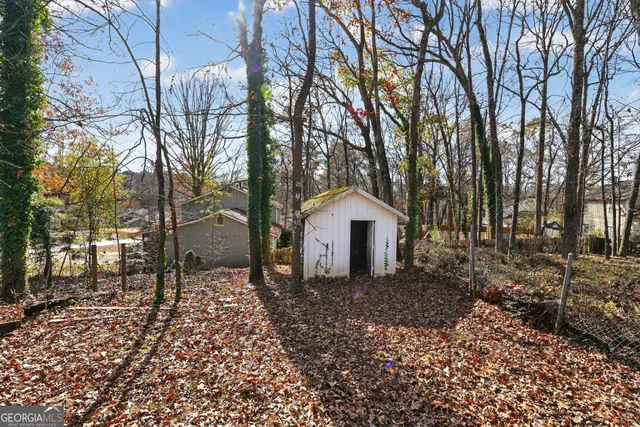a view of a house with a yard and trees