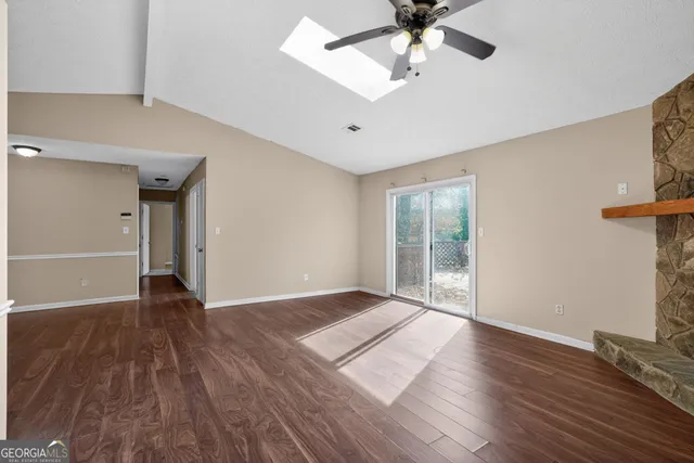 wooden floor in an empty room with a window