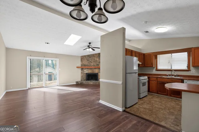 a view of kitchen with furniture stove and wooden floor
