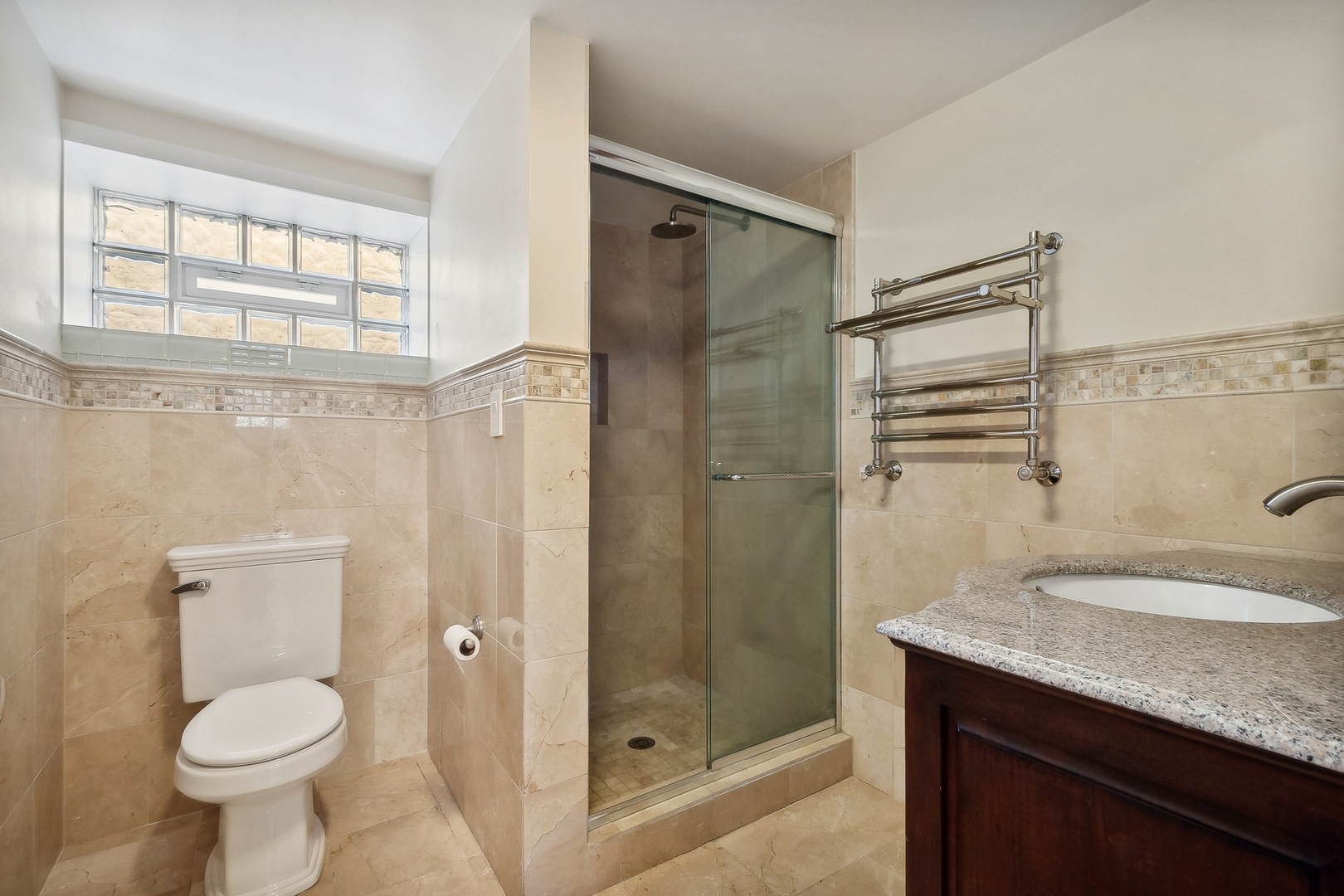 504 Maple Avenue Wilmette, IL 60091 - Photo 13 of 20 a bathroom with a granite countertop sink toilet and shower