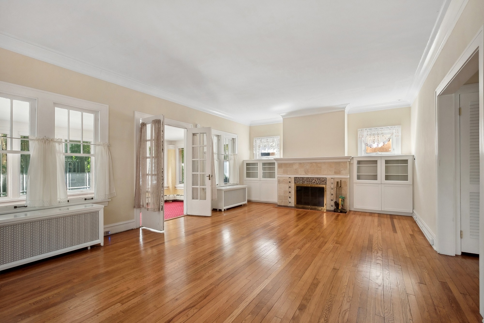 504 Maple Avenue Wilmette, IL 60091 - Photo 2 of 20 a view of a livingroom with wooden floor fireplace and windows