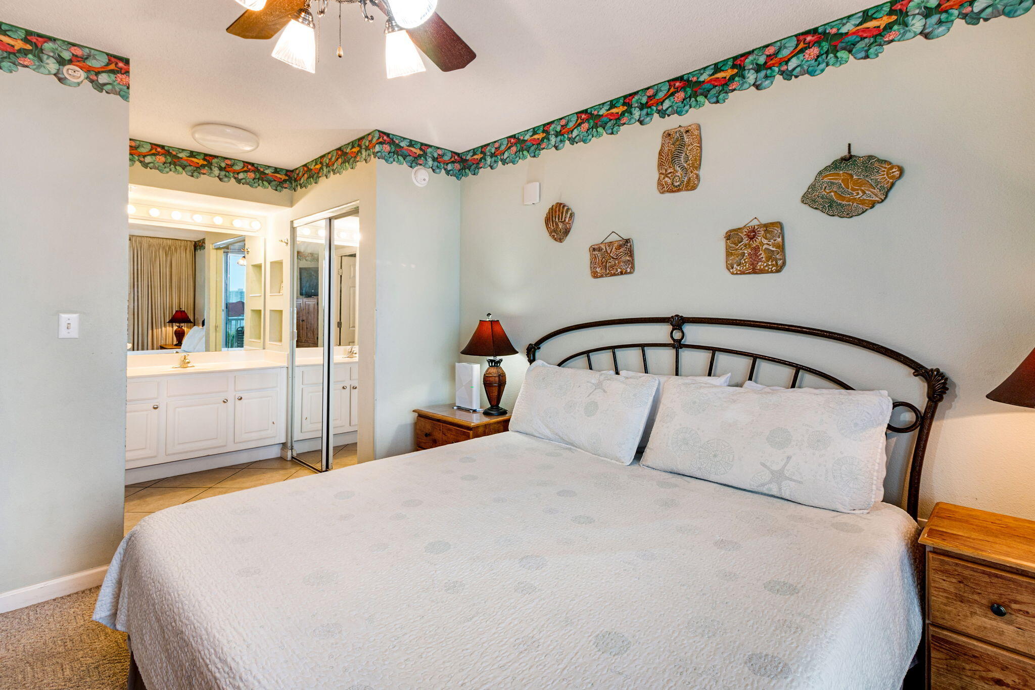 970 Highway 98, Unit 303 Destin, FL 32541 - Photo 26 of 42 a bedroom with a bed and a chandelier