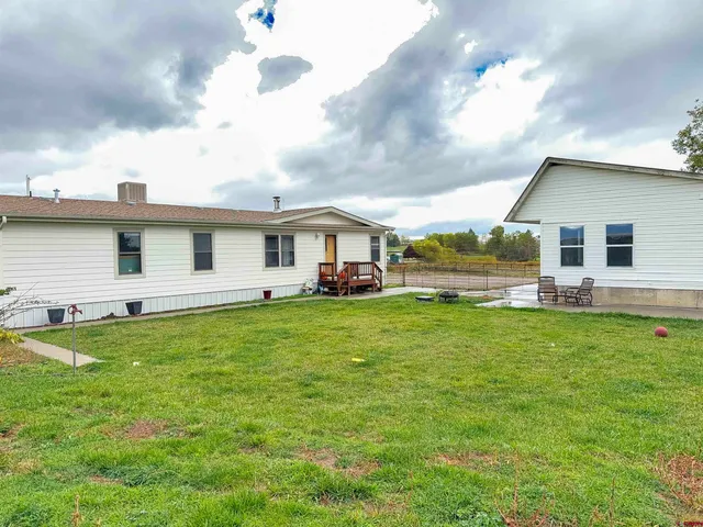 a front view of house with yard and seating area