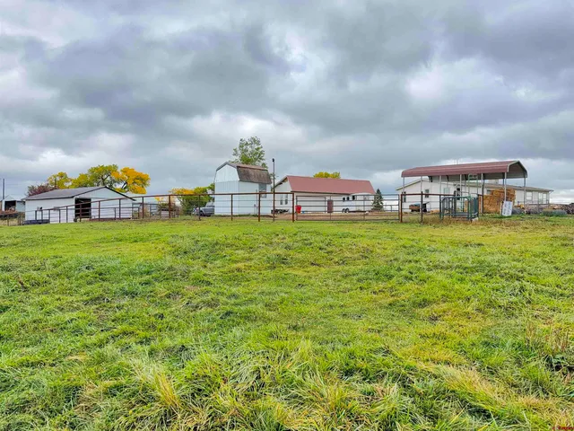 a view of a house with a yard and sitting area