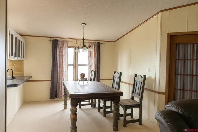 a view of a dining room with furniture and window