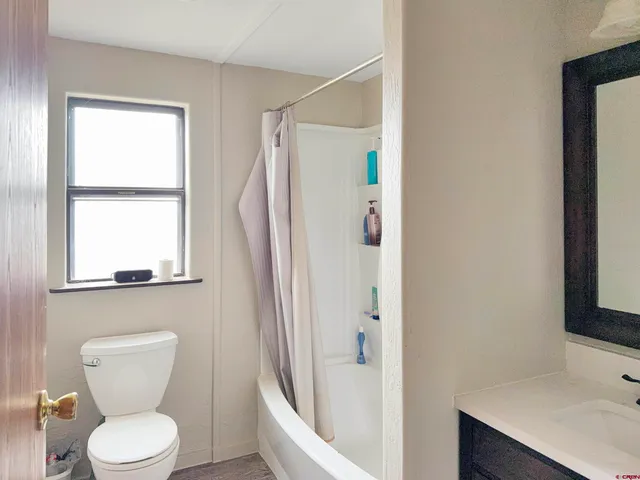 a white toilet sitting next to a bathroom sink