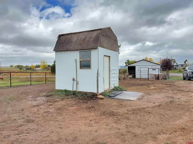 a view of a house with backyard and ocean view