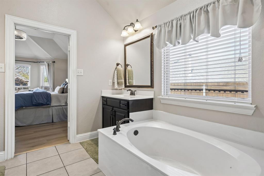 3917 Gatewick Drive Rockwall, TX 75087 - Photo 17 of 34 a spacious bathroom with a tub a double vanity sink and mirror