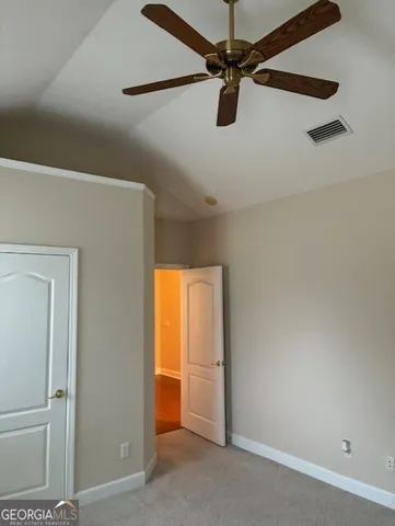 a view of a room with a ceiling fan