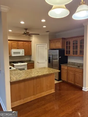 a large kitchen with kitchen island a large counter top space appliances and cabinets