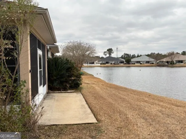 a view of a lake with houses in the back