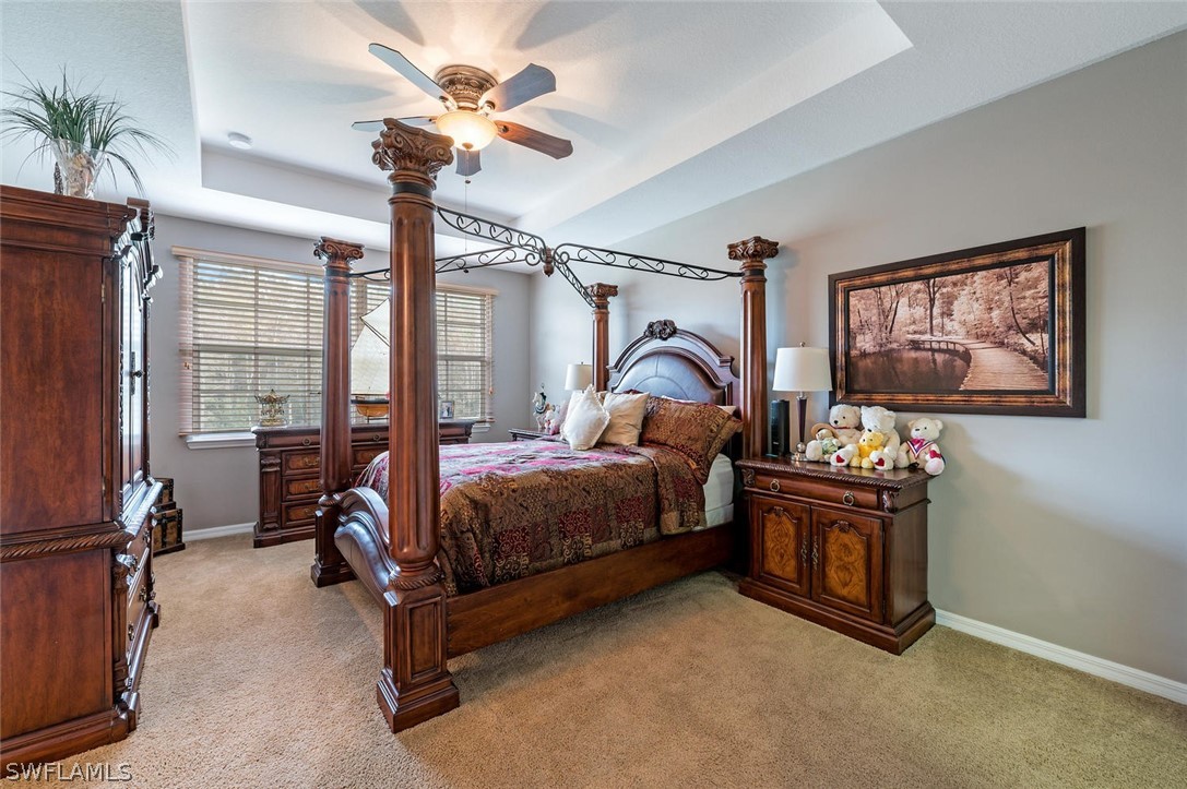4032 Cherrybrook Loop Fort Myers, FL 33966 - Photo 12 of 22 a bedroom with a bed and a chandelier