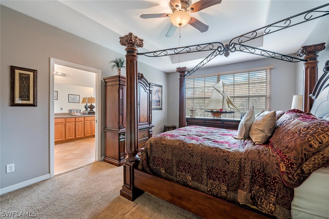 4032 Cherrybrook Loop Fort Myers, FL 33966 - Photo 13 of 22 a bedroom with a large bed and a chandelier