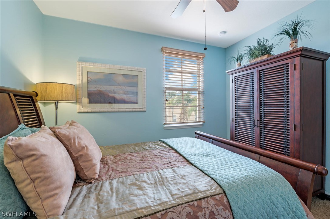 4032 Cherrybrook Loop Fort Myers, FL 33966 - Photo 17 of 22 a bedroom with a large bed and a chandelier