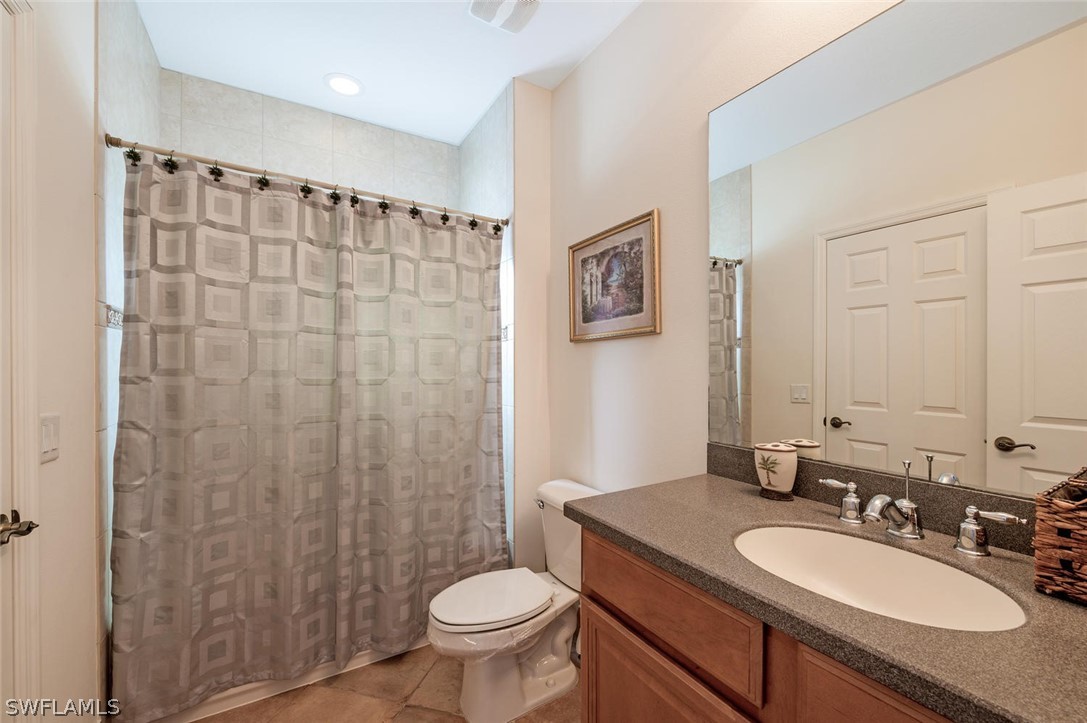 4032 Cherrybrook Loop Fort Myers, FL 33966 - Photo 18 of 22 a bathroom with a granite countertop sink toilet a mirror a shower and a sink