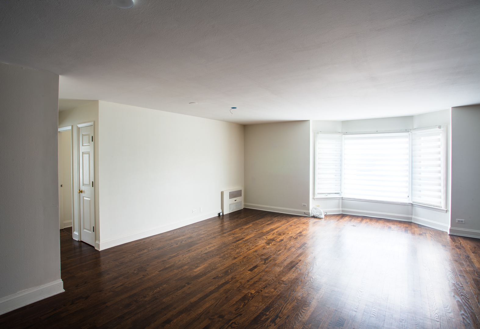 2400 Archbury Lane, Unit 1E Park Ridge, IL 60068 - Photo 12 of 18 a view of an empty room with wooden floor and a window