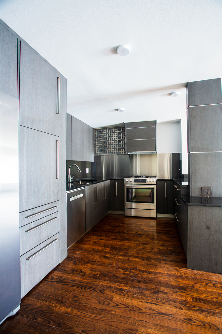 2400 Archbury Lane, Unit 1E Park Ridge, IL 60068 - Photo 9 of 18 a kitchen with granite countertop a refrigerator and a stove