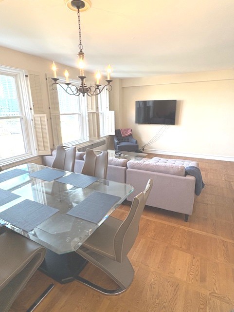1585 Ridge Avenue, Unit 608 Evanston, IL 60201 - Photo 7 of 15 a living room with couches and kitchen view with wooden floor