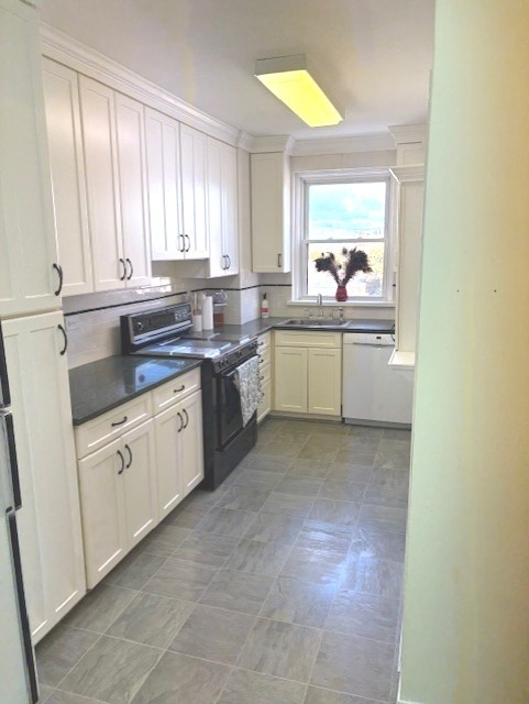 1585 Ridge Avenue, Unit 608 Evanston, IL 60201 - Photo 9 of 15 a kitchen with a sink stove and cabinets